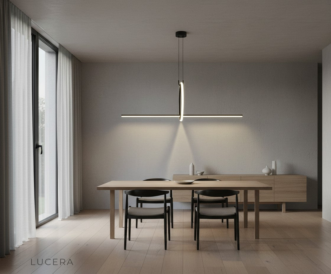 Black geometric pendant lamp suspended over minimalist workspace with soft ambient lighting