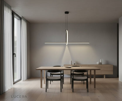 Black geometric pendant lamp suspended over minimalist workspace with soft ambient lighting