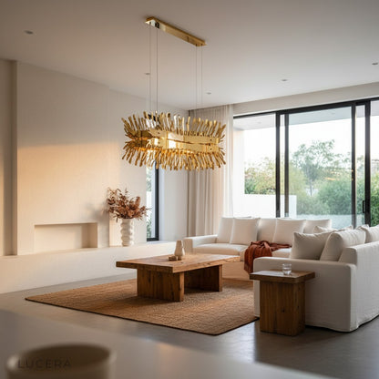 Magne gold chandelier hanging above kitchen island with adjustable cords