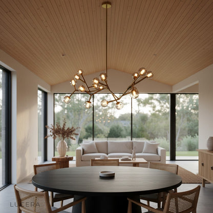 Norn chandelier with reflective glass orbs against dark wall at night