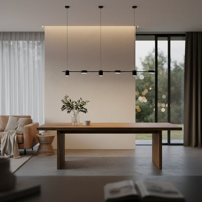 Rind black and gold pendant lamp over cozy reading nook with armchair