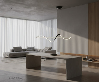 Skuld Wave LED chandelier illuminated at night casting soft shadows on ceiling
