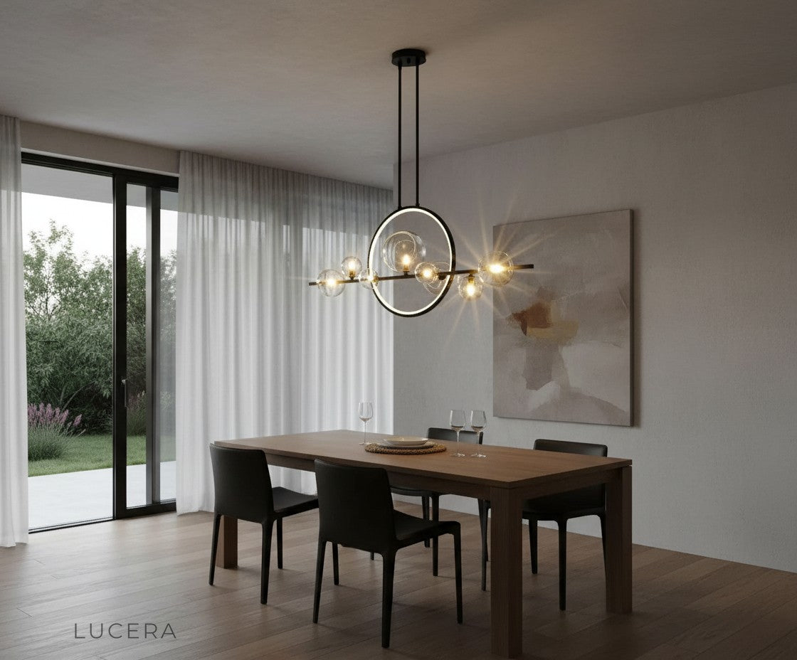 evening shot of Vor glass bubble chandelier illuminating rustic dining room with brick wall