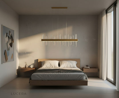 Gold Alma chandelier with adjustable height rods in luxurious open-plan living area