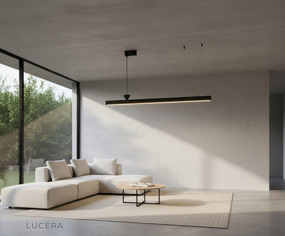 Angelo chandelier with acrylic diffusers casting soft light over a modern kitchen island