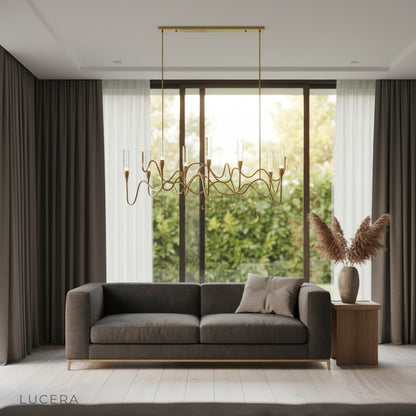 gold crystal chandelier hanging above a contemporary living room sofa with soft daylight from windows