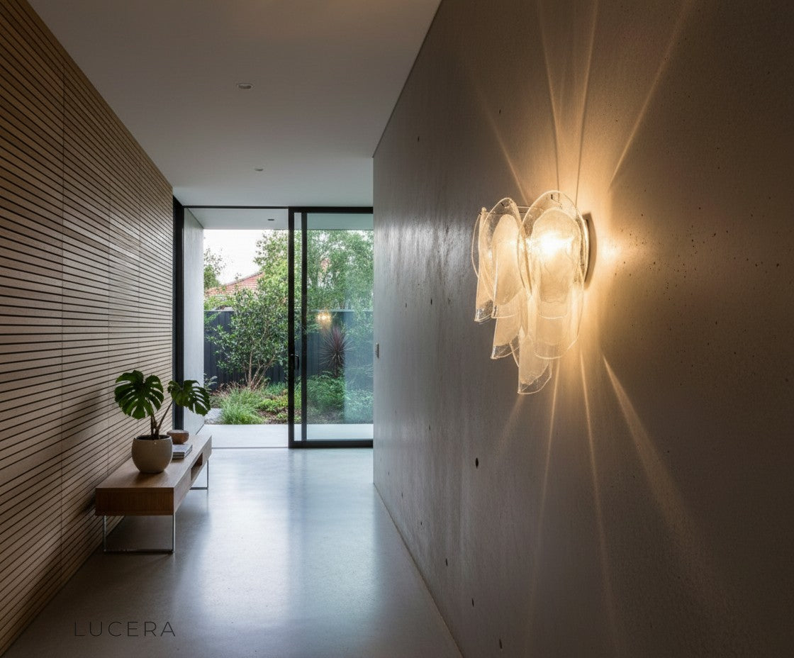 Carme Murano glass wall light illuminating a dark elegant bedroom with soft romantic nighttime glow