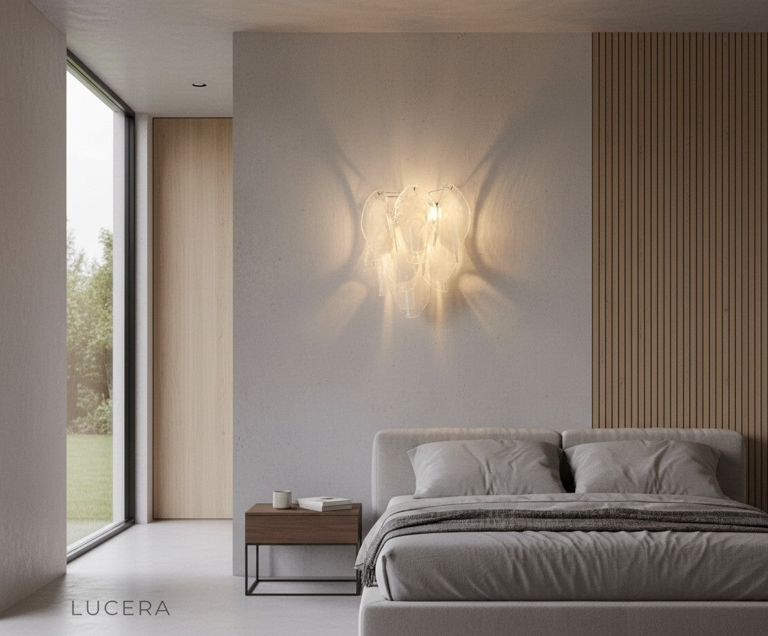 Carme sconce in a luxurious dining room setting with metallic accents and warm inviting atmosphere