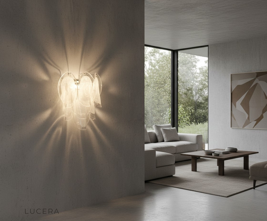 Carme glass wall sconce casting intricate light patterns on a neutral wall in a serene lounge corner