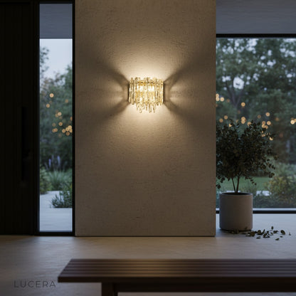 Cielo Murano sconce casting atmospheric glow in a dim bedroom with linen bedding