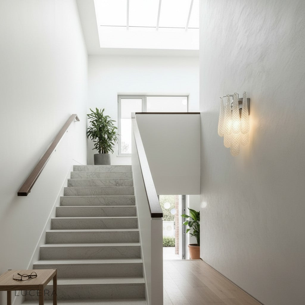 Pair of Circo wall sconces flanking a mirror in a chic bedroom with soft ambient lighting