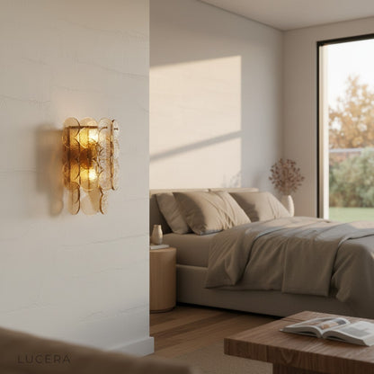 Colmo Caspian wall light in brushed gold finish mounted above wooden console table