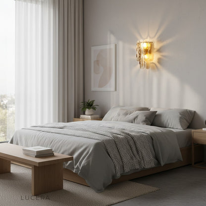 nighttime lifestyle shot of Colmo Caspian wall light casting geometric patterns on wall
