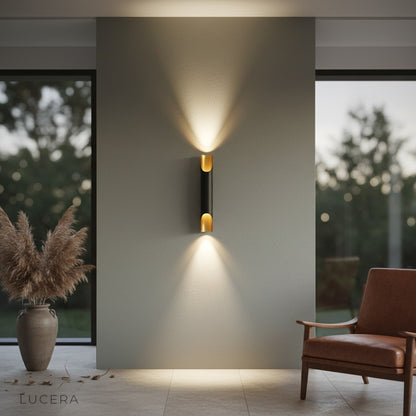 Crema Nordic wall lamp black gold paired with a leather chair in a contemporary reading nook