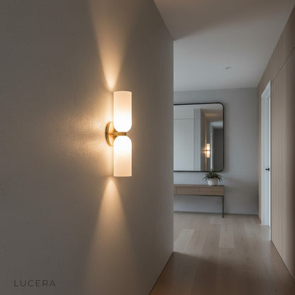Contemporary bathroom with Dolce white glass wall sconce above mirror reflecting light