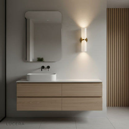 Nighttime lifestyle shot of Dolce double wall sconce casting elegant ambient light in lounge