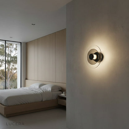 Domo Disc sconce casting ambient glow in contemporary living room at dusk