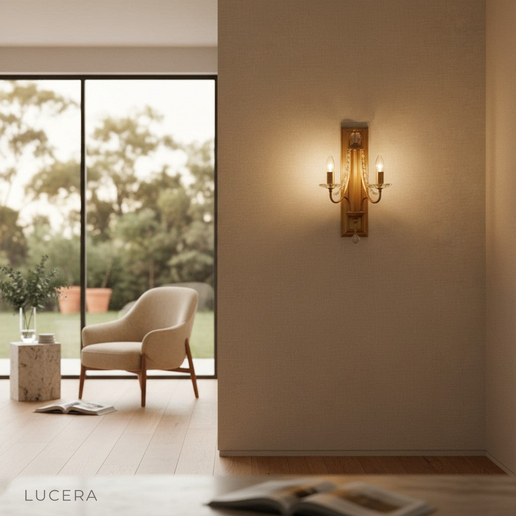 Candle-shaped sconce with warm glow illuminating a bedroom wall near bed