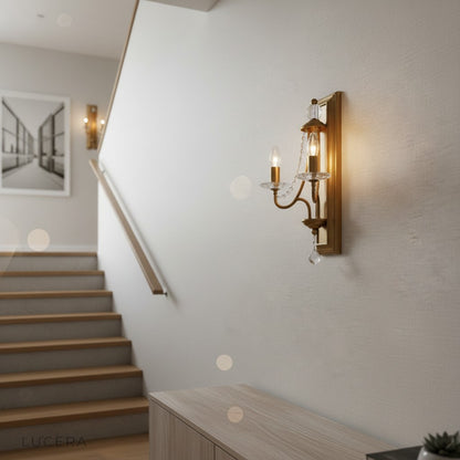 Retro iron wall sconce with crystals above a dining table in ambient evening light