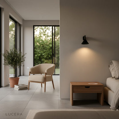 Bauhaus lamp with cool LED light against dark textured wall