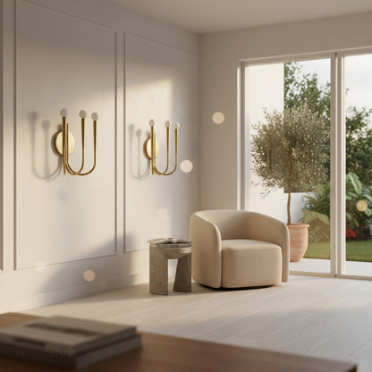 Fiore Art-Deco LED wall sconce illuminating a cozy bedroom corner with elegant gold accents