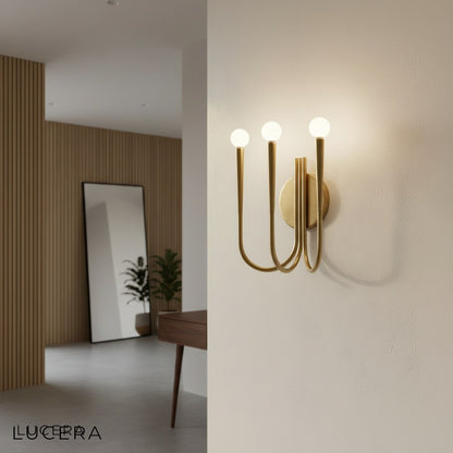 Ambient evening shot of Fiore Art-Deco sconce casting warm light in a dark hallway