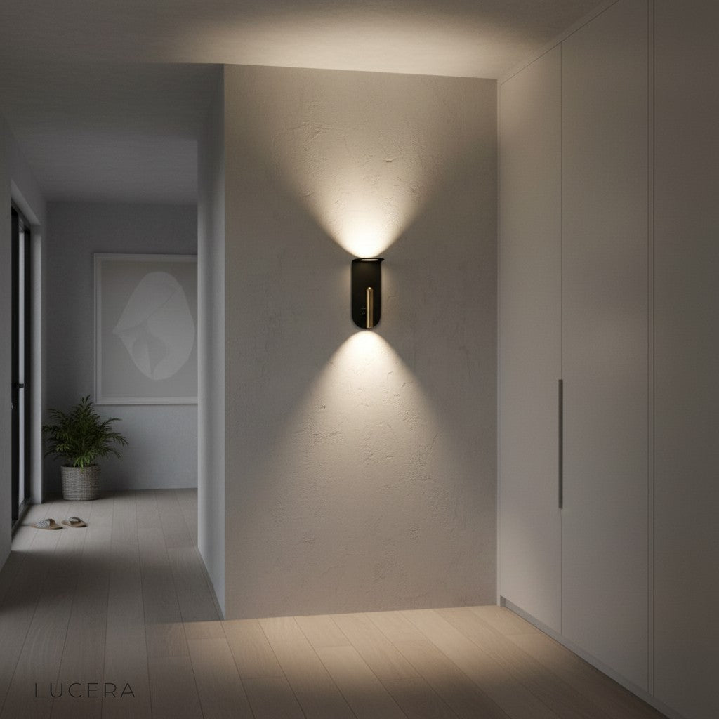 modern sconce casting warm light in chic reading nook with gold and black decor