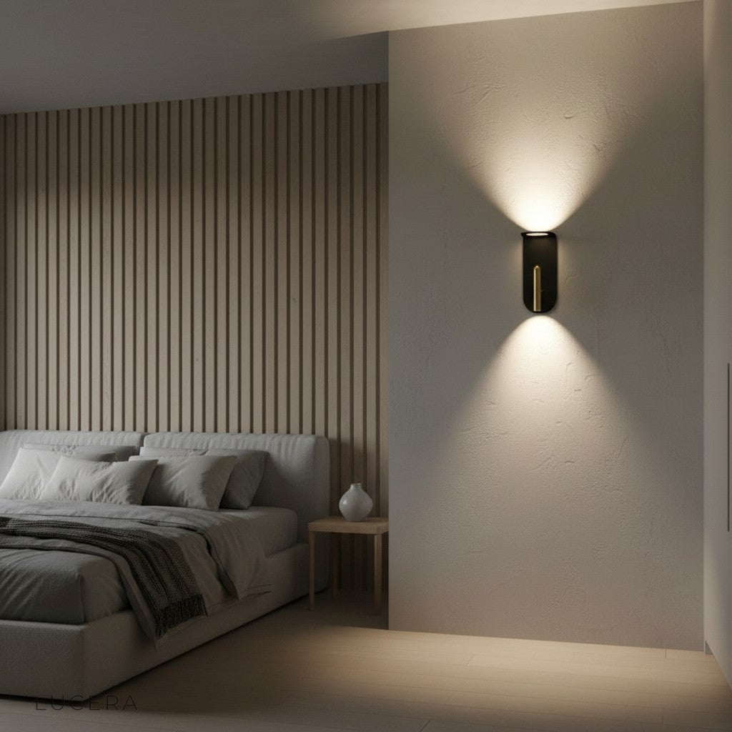 black and gold wall light glowing at dusk in modern dining room with ambient shadows