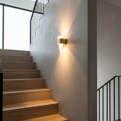 nighttime ambient shot of Passo Shark Tooth lamp in a cozy reading nook with armchair