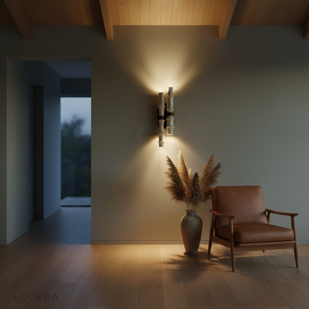 Salvo LED wall lamp at dusk casting warm glow on textured wall