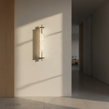 Nighttime lifestyle shot of Amalfi wall lamp illuminating a dark accent wall