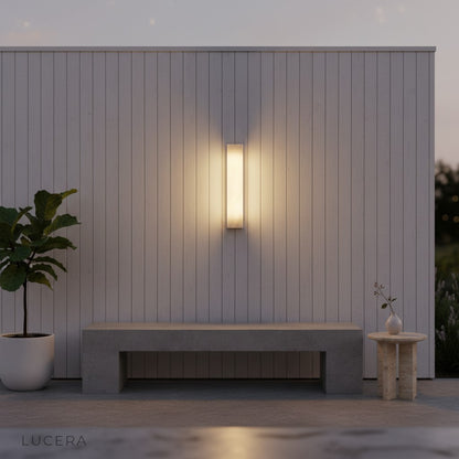 Varenna sconce in reading nook with warm 3000K light and bookshelf backdrop