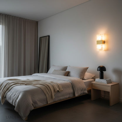 sculptural marble wall lamp above bedside table in serene bedroom setting