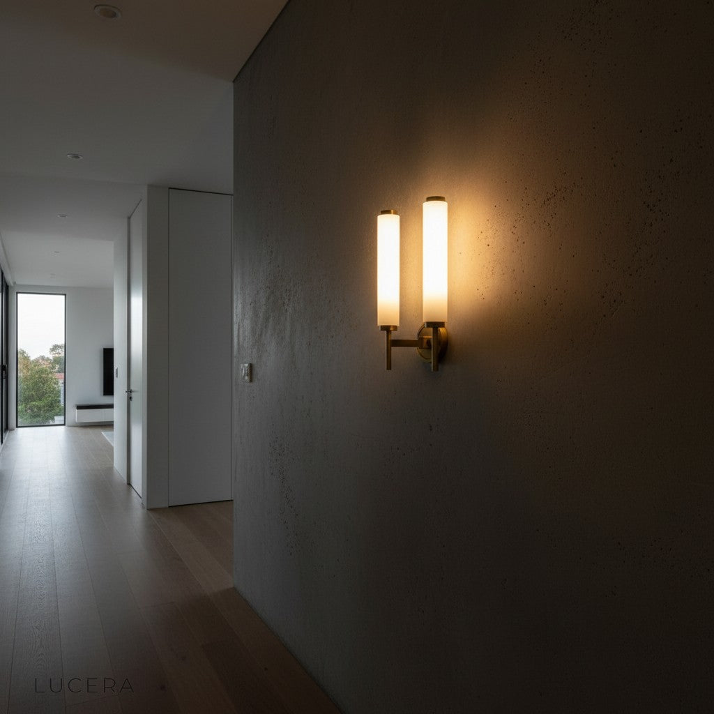 evening shot of Outre wall lamp illuminating textured plaster wall
