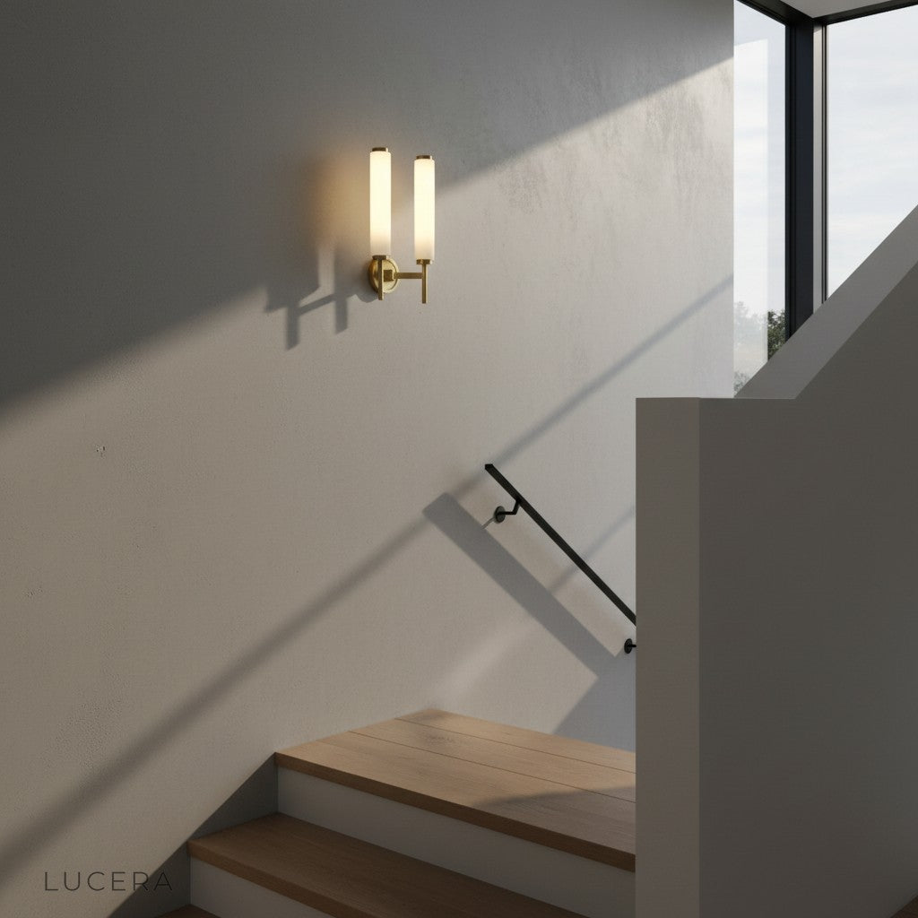 pair of copper marble wall lamps flanking a modern entryway mirror