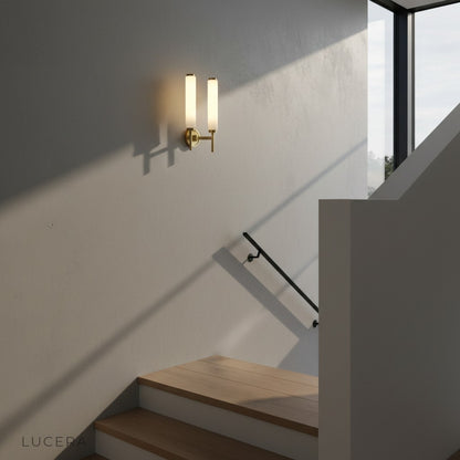 pair of copper marble wall lamps flanking a modern entryway mirror