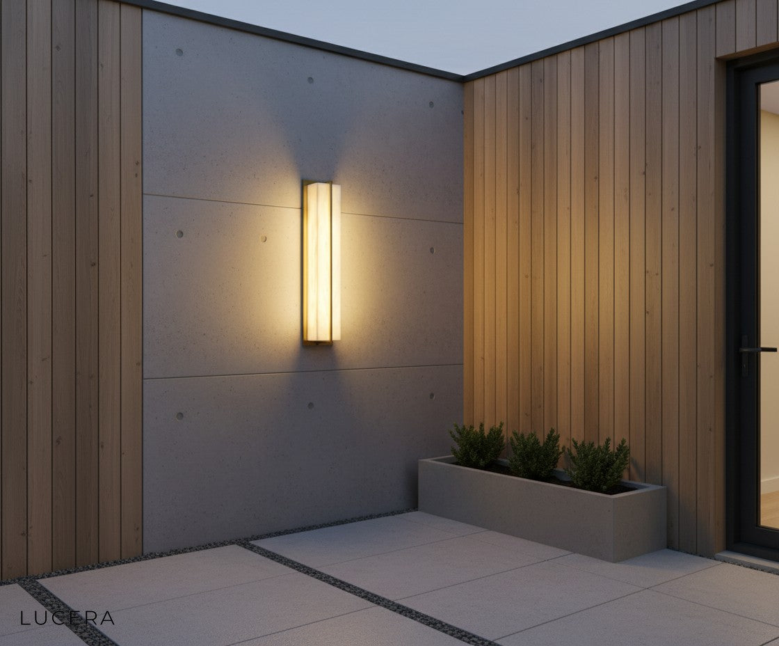 two Parure lamps flanking a modern outdoor fireplace in a backyard