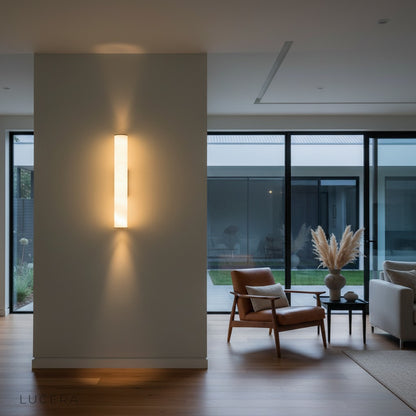 nighttime ambiance shot of Rafale wall lamp casting warm glow in hallway