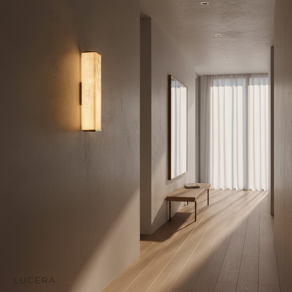 Nighttime lifestyle shot of Ultime marble lamp illuminating a cozy reading nook