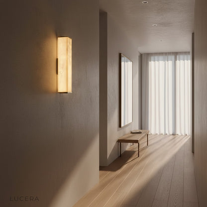 Nighttime lifestyle shot of Ultime marble lamp illuminating a cozy reading nook