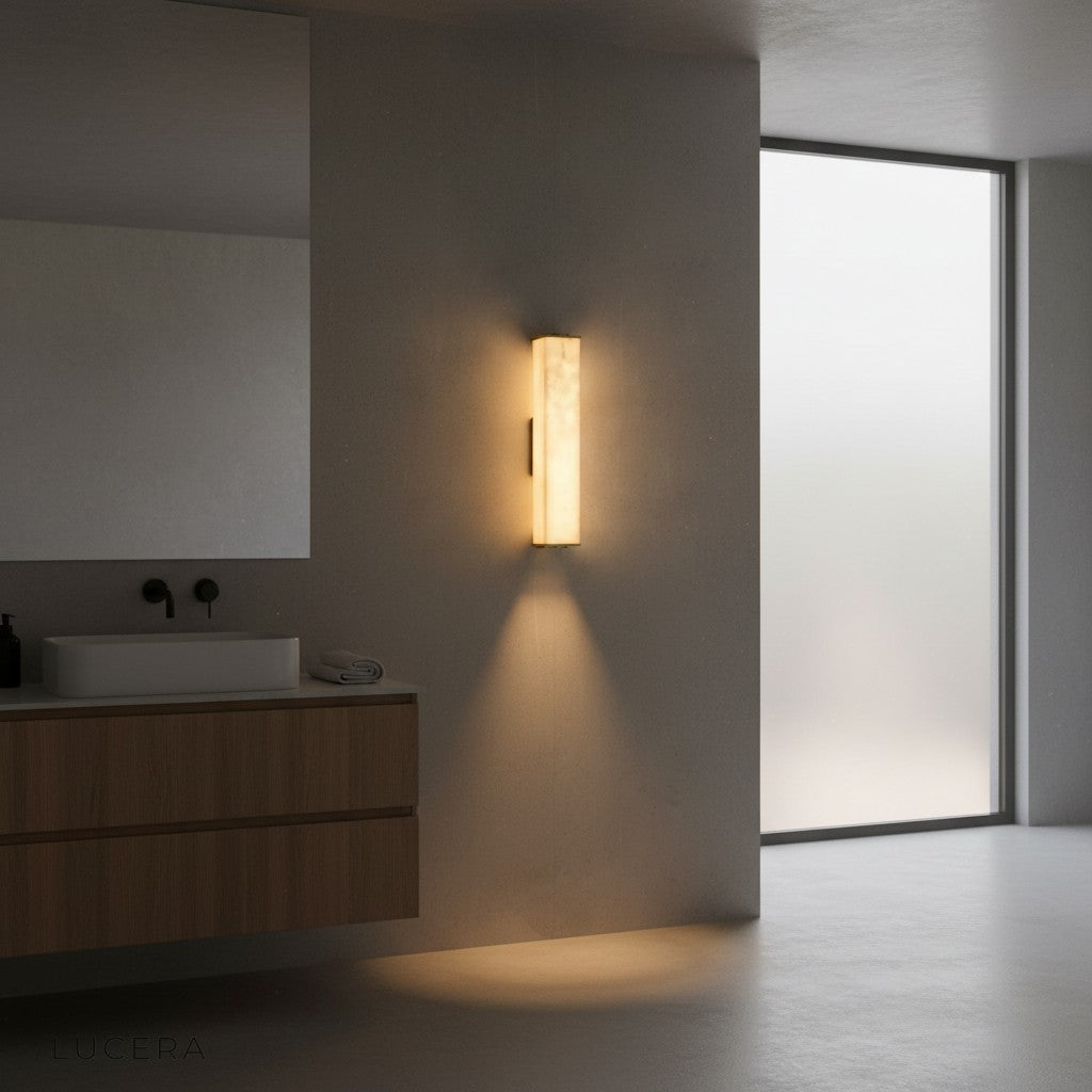 Elegant marble brass sconce in a hotel-style entryway with dimmed ambient lighting