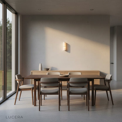 three sizes of Vague marble wall lamps displayed together on a gallery wall with warm lighting