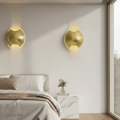 Lucera wall lamp in reading nook casting soft ambient glow over armchair