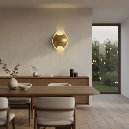 Wenge and brass semi circle sconce illuminated in dark moody interior