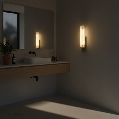 Sculptural marble lamp against dark wall for dramatic contrast