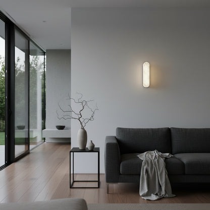 Abacus marble wall lamp illuminated at night casting warm light in a cozy bedroom