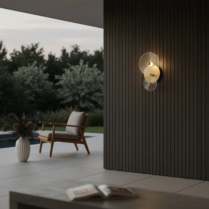 nighttime lifestyle shot of circular wall lamp casting sparkling light in hallway