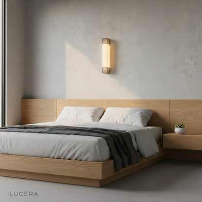 Astragal marble wall lamp highlighting tall ceilings in contemporary dining room