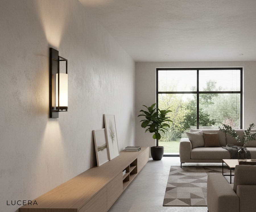 Gold finish wall light illuminating dark accent wall in contemporary bedroom