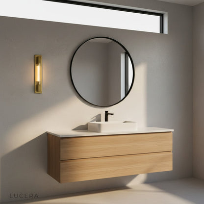 Nighttime ambiance of Verve bronze sconce lighting a cozy hallway with plants